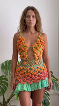 Front view of model wearing Lime Green 3D crochet cutout mini dress with orange and pink accents
