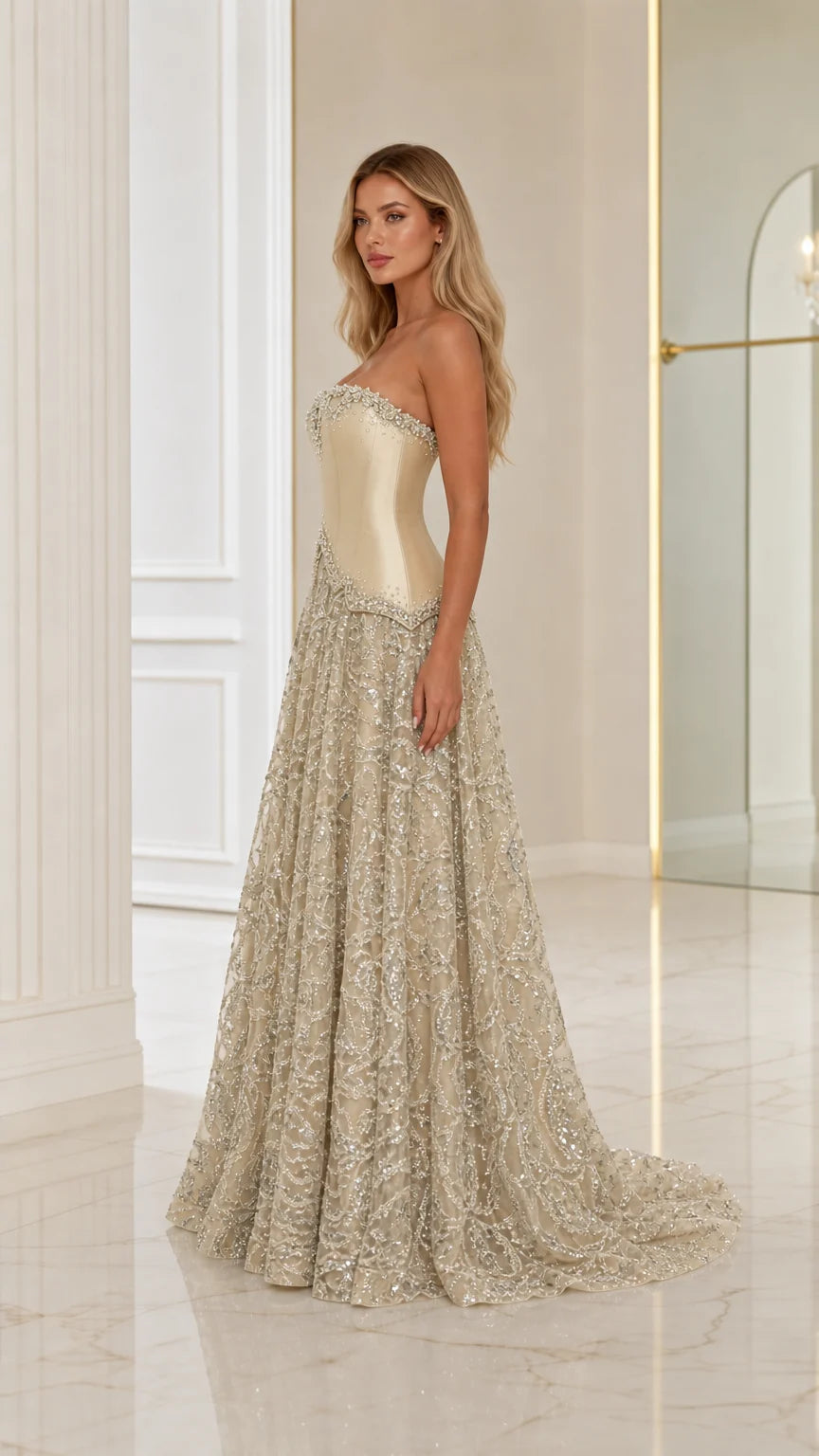 Side profile of model wearing a Champagne basque waist formal dress with embroidered skirt