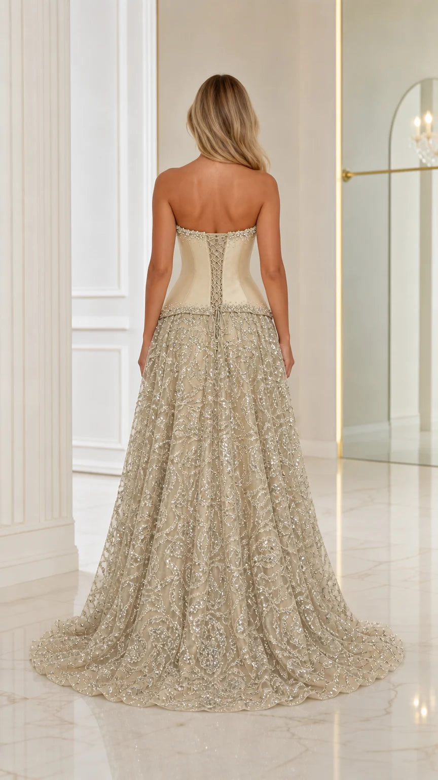 Back view of model wearing Champagne strapless corset evening gown showing train