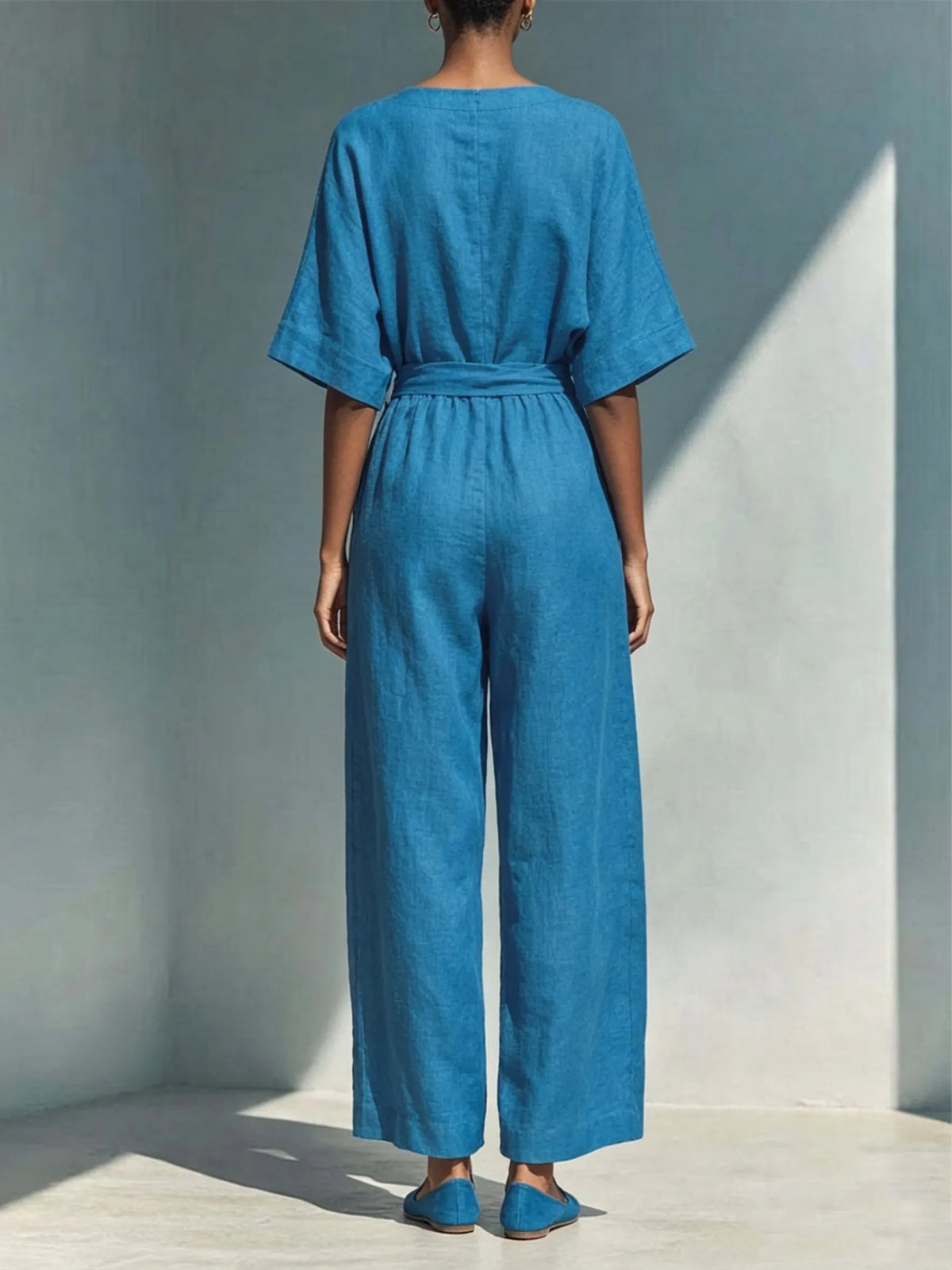Wrap-style Deep V-neck Short-sleeve Cotton-linen Wide-leg Jumpsuit Featuring A Matching Self-tie Belt And Side Wooden Button Detail.